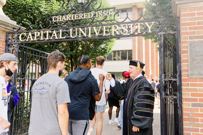President Kaufman Welcoming Students Through The Gate