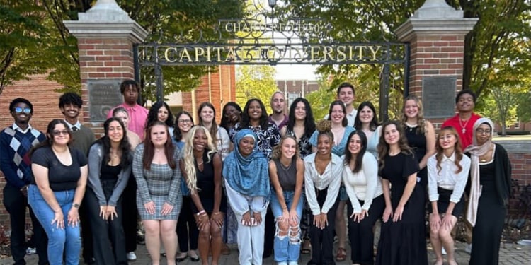 Members of the Student Senate pose in front of the Memorial Gateway