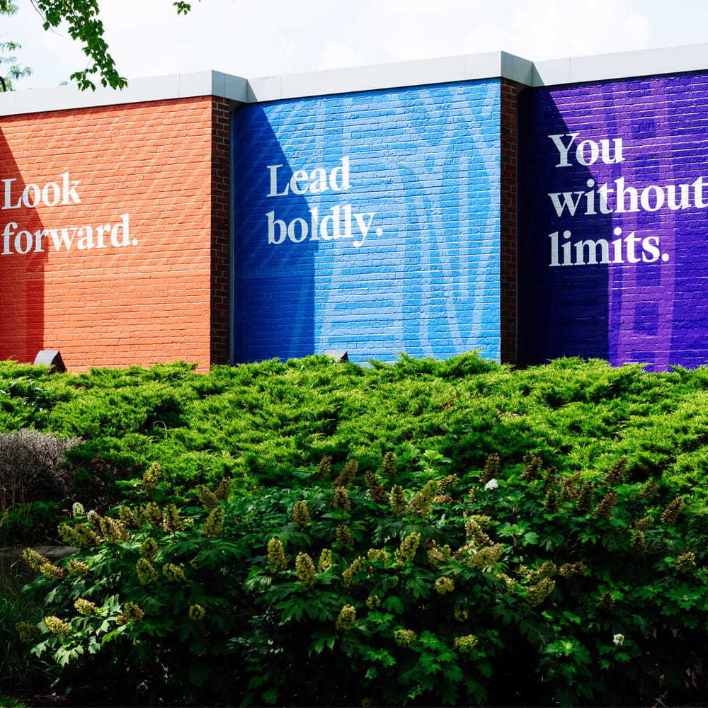 Wall art reading "Look Forward." "Lead boldly." "You without limits."