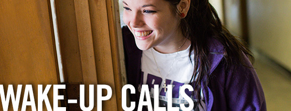 college student standing in a doorway smiling