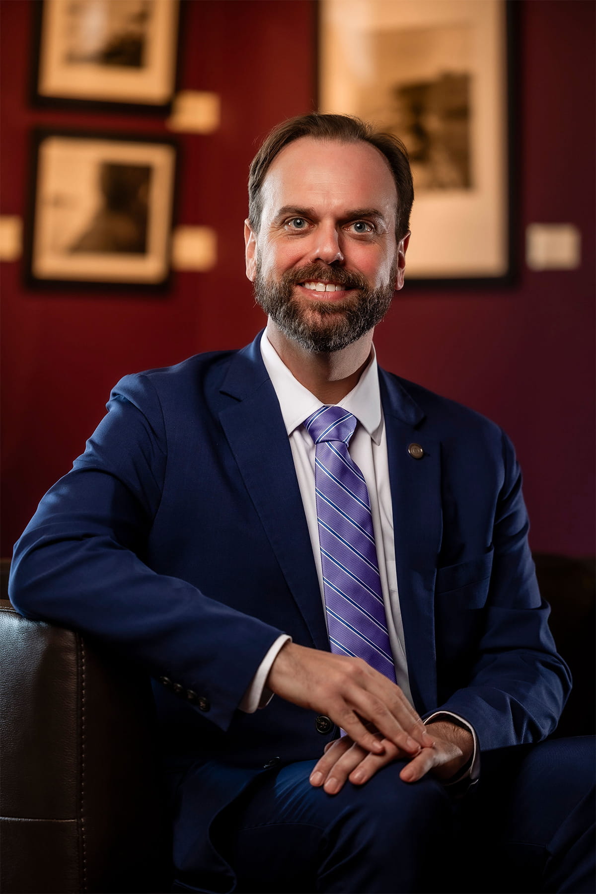 A photo of Dr. Jared R. Tice smiling while wearing a suit and purple tie.