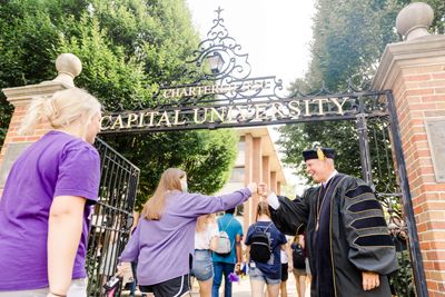 President Kaufman Welcoming Student With Fistbump